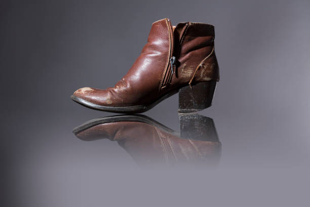 istock old, damaged female shoes with gray background 657818408