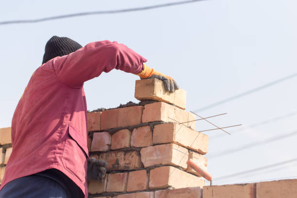 istock Worker builds a brick wall in the house 657818774
