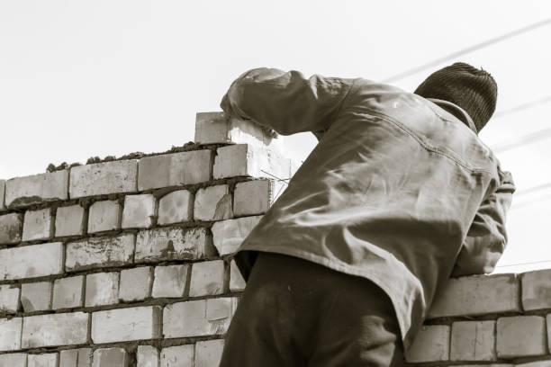 istock Worker builds a brick wall in the house 657818866