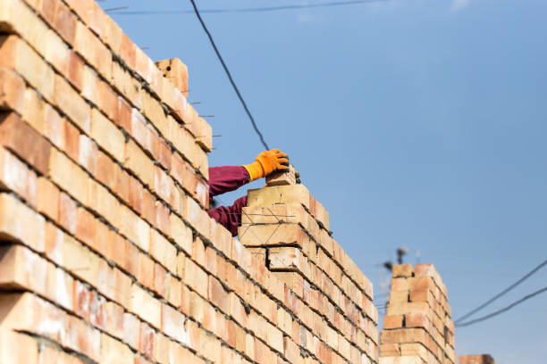 istock Worker builds a brick wall in the house 657819026