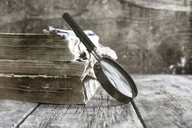 istock old scratched effect on photo magnifying glass and old book 657819602