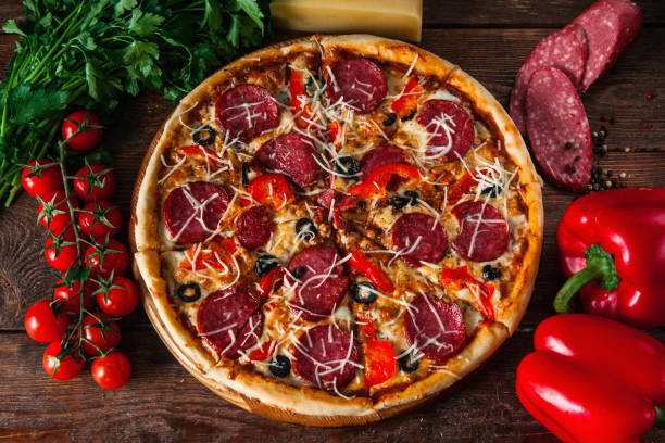 istock Homemade delicious pizza served on rustic table 657823168
