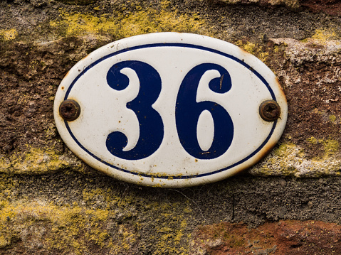 enameled old house number 36 in wihte and blue