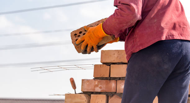 istock Worker builds a brick wall in the house 657825624