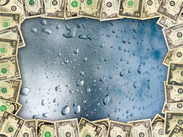 istock Frame from the dollars on the surface with drops of water 657832888