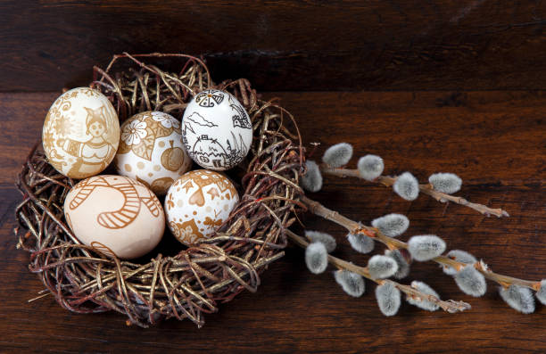 istock Easter theme. hand painted Easter eggs and willow branch with blossom on the wooden texture 657836226