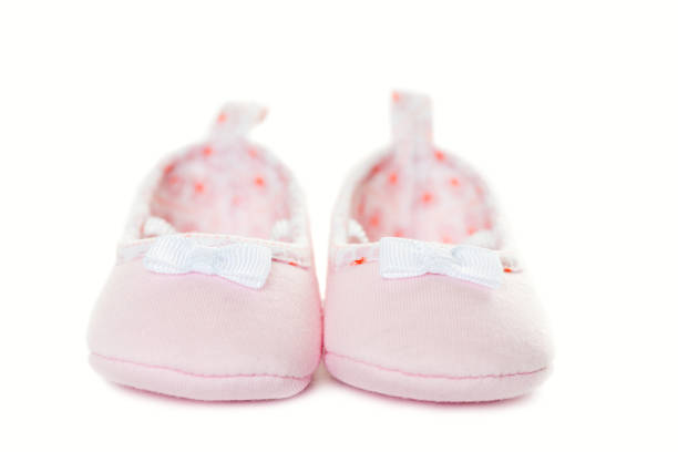 istock Pink baby sneakers closeup isolated 657837034