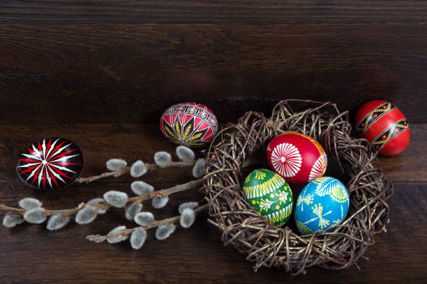 istock Easter theme. hand painted Easter eggs and willow branch with blossom on the wooden texture 657837202