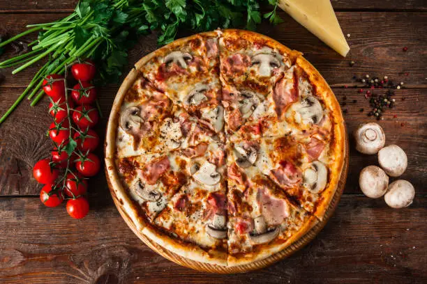 Photo of Pizza with mushrooms on wooden table. Italian food