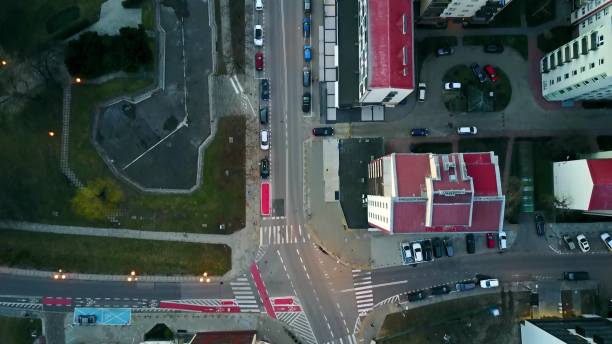 istock Aerial camera following biker in blue riding his cycle along bicycle paths, top view. Modern urban residential area 657840298