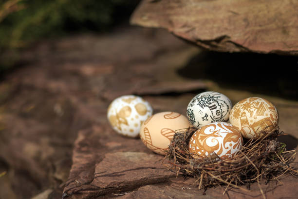 istock Easter eggs in the nest on the stone texture, blurred background. 657840316