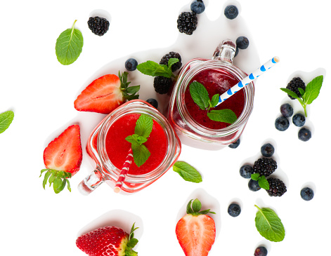 Top view of smoothies made with fresh berries ( strawberry; blueberry and blackberry ) isolated on white background.