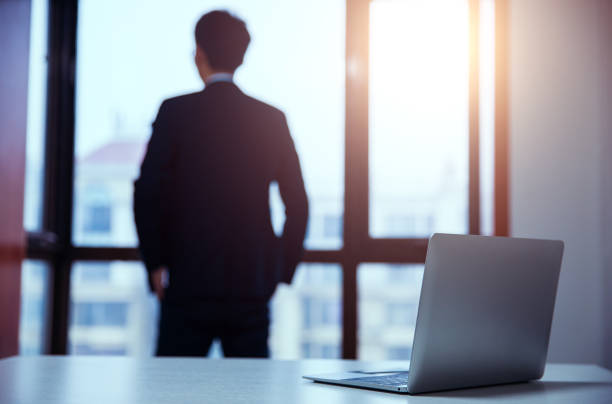 istock Businessman standing by window in office 657842218