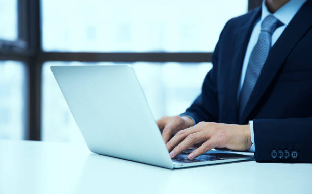 istock Close-Up Of Man Using Laptop On Table 657843604