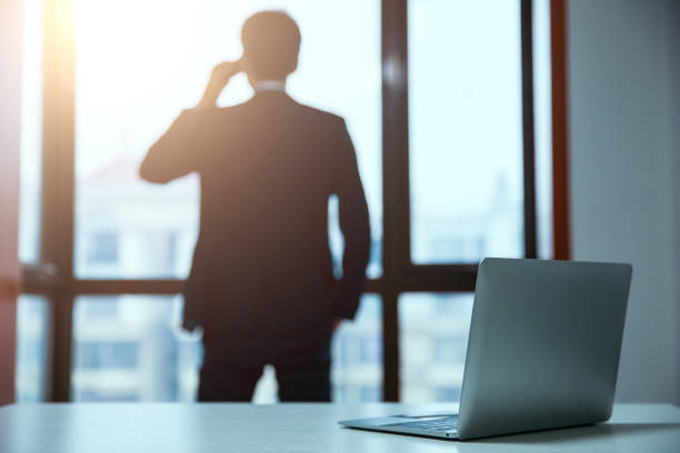 istock businessman talking on cell phone at office 657843892