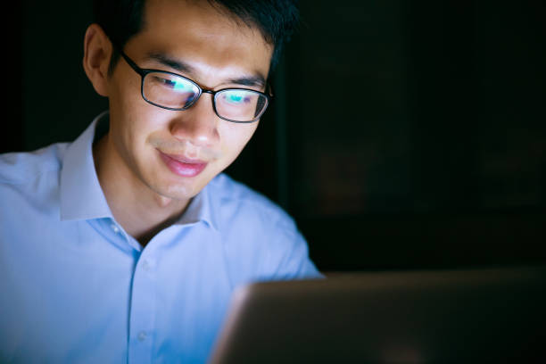 istock Businessman working on laptop at night in office 657844100