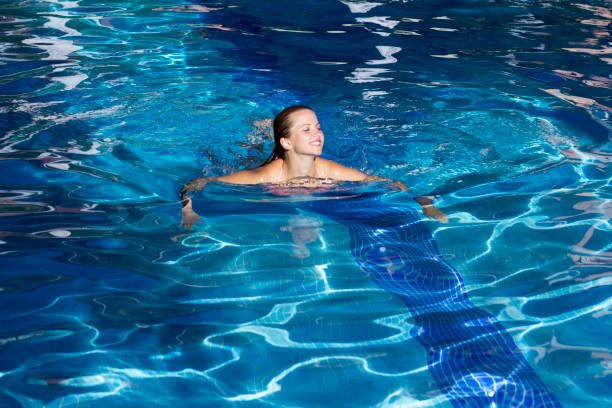 istock Young woman swimming in pool 657848056