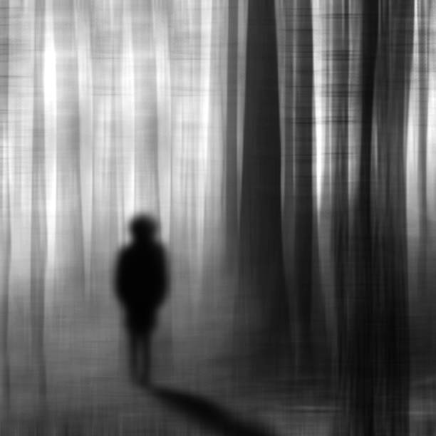 istock Surreal man walking in the forest at night. 657850844