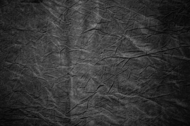 istock Texture of dark grey crumpled fabric 657857512