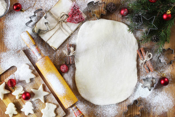 Cooking butter biscuits of different shapes on a wooden table