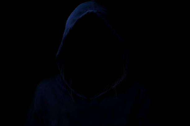 istock Mysterious, Low light image of Hacker. Unrecognizable person in the hood. 657859284