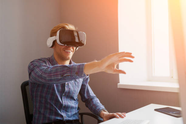 istock Man touching the air wearing VR goggles 657864594