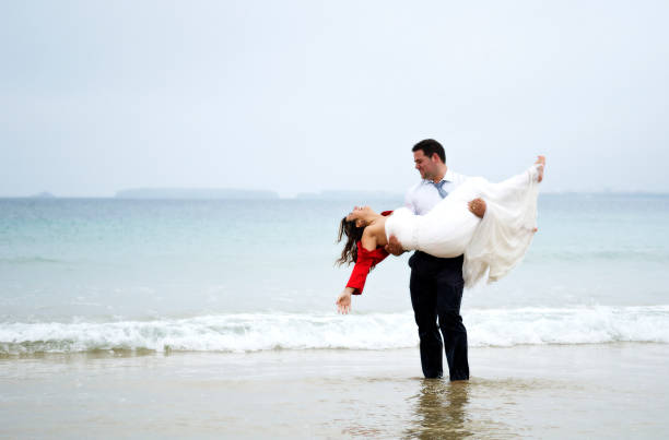 istock Grooms couple playing on seawater 657864678