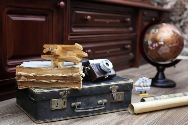 istock composition on a wooden floor vintage globe with old leather sui 657864848