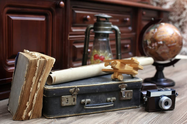 istock composition on a wooden floor vintage globe with old leather sui 657865210