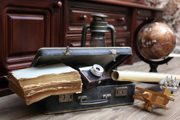 istock composition on a wooden floor vintage globe with old leather sui 657865346