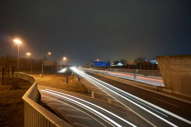 Highway at night with lighttrails and lightstars