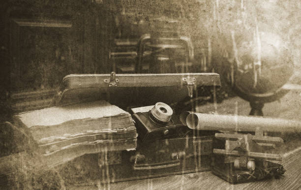 composition on a wooden floor vintage globe with old leather suitcase with objects for travel