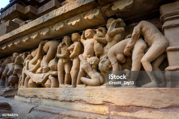 Erotic Scene On Sculptured Surface Of Famous Indian Temple Of Khajuraho Stock Photo - Download Image Now