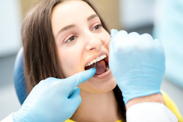 istock Cleaning teeth with dental floss 657868534