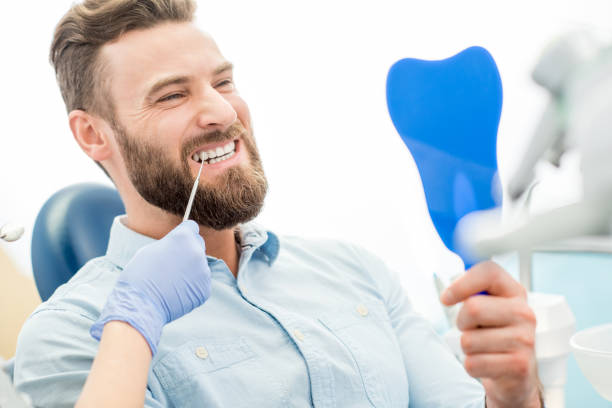 istock Man with great smile at the dental office 657871724