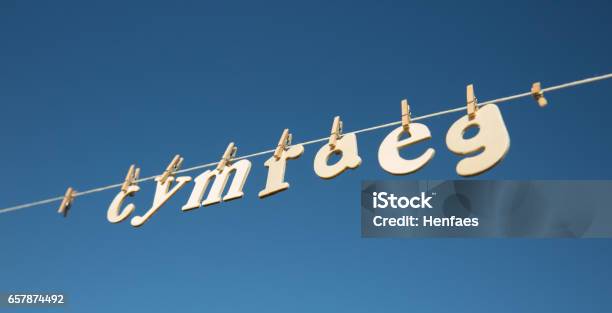 Cymraeg Spelt Out On A Clothesline With Pegs Holding Letters Stock Photo - Download Image Now