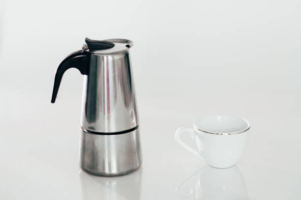 istock geyser coffee maker and a white coffee Cup isolated on white. 657874530