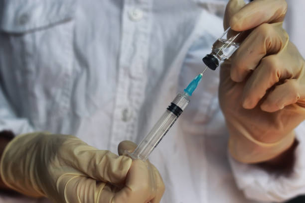 istock nurse hands holding syringe and ampoule 657878028