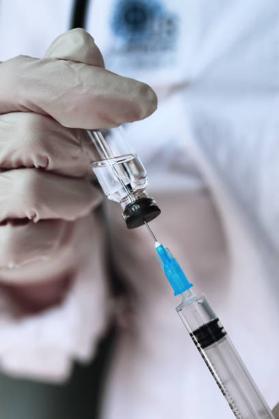 istock health worker dials the vaccine into a syringe 657878098