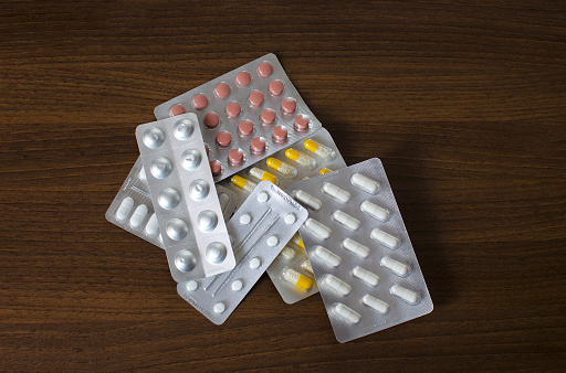 View of the tray of drugs lying in a pile on a wooden background