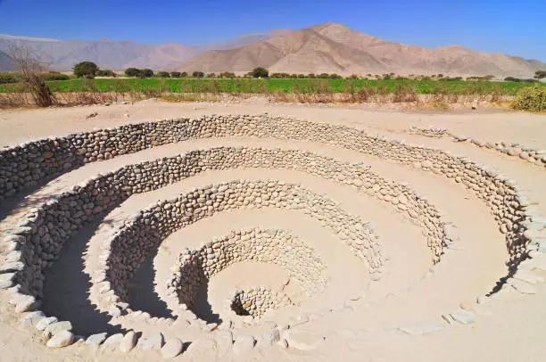 Concentric terraces of stone and an underground aqueduct, built in the pre-Inca period in the Nazca Desert, Peru.