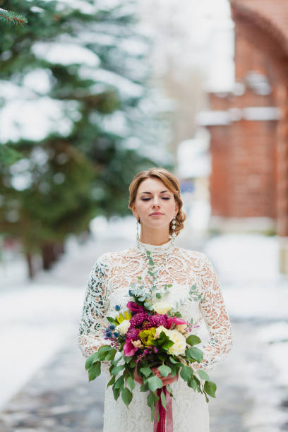 Close-up portrait of a bride with a bridal bouquet stock photo