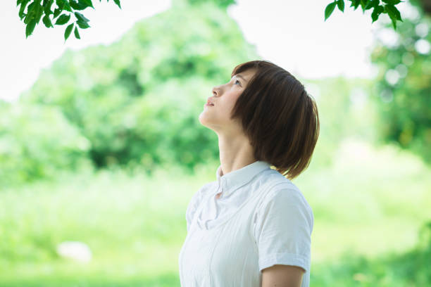 istock Young Asian woman in green nature 657884270