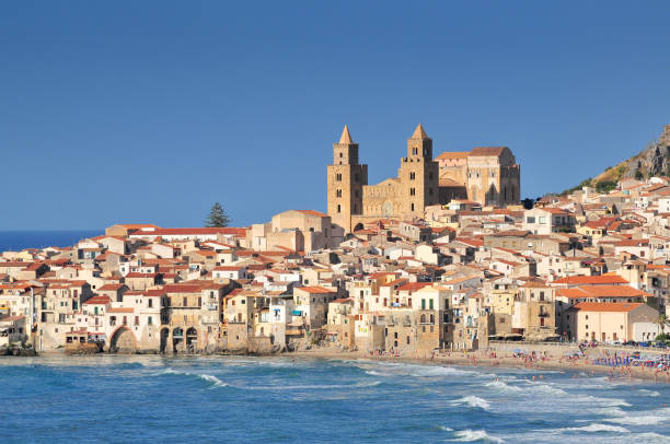 Houses and cathedral in background Cefalu Sicily. Houses along the shoreline and cathedral in background Cefalu Sicily. cefalu stock pictures, royalty-free photos & images