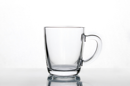 Empty transparent glass coffee and latte mug, cup on a table. Product Mock-up