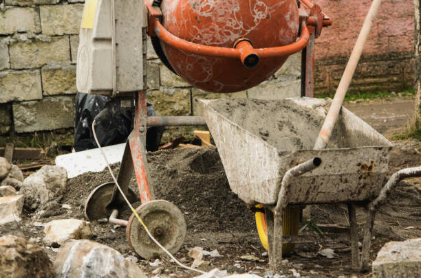 istock Cement mixer, wheelbarrow and shovel on the construction place 657901596
