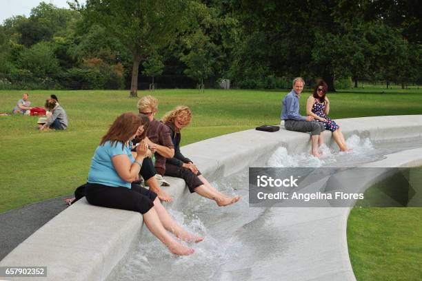 A Group Of People By The Diana Memorial Fountain In Hyde Park London Stock Photo - Download Image Now