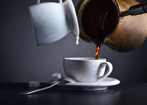 istock Cup of coffee with milk on dark background 657905390