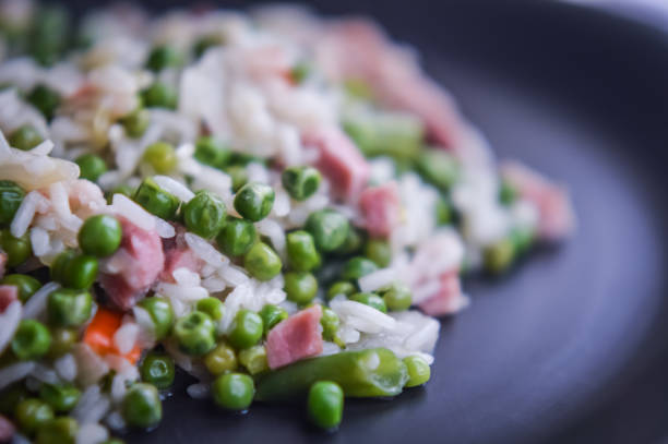 istock Rice with peas, vegetables and bacon, risotto closeup 657911336
