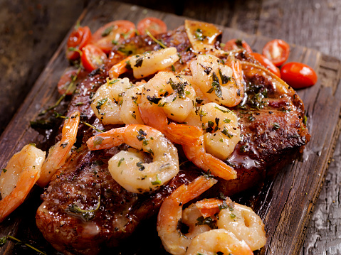 Grilled T-Bone Steak with Shrimp Scampi  Sauteed in a Wine, garlic, butter Sauce